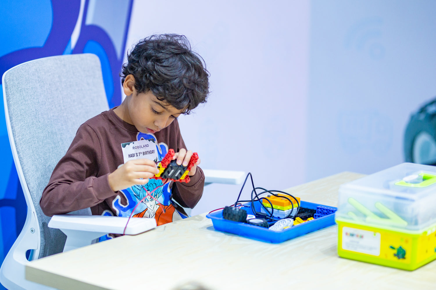 Young child engaged in RoboThink STEM activities like robotics at RoboLand