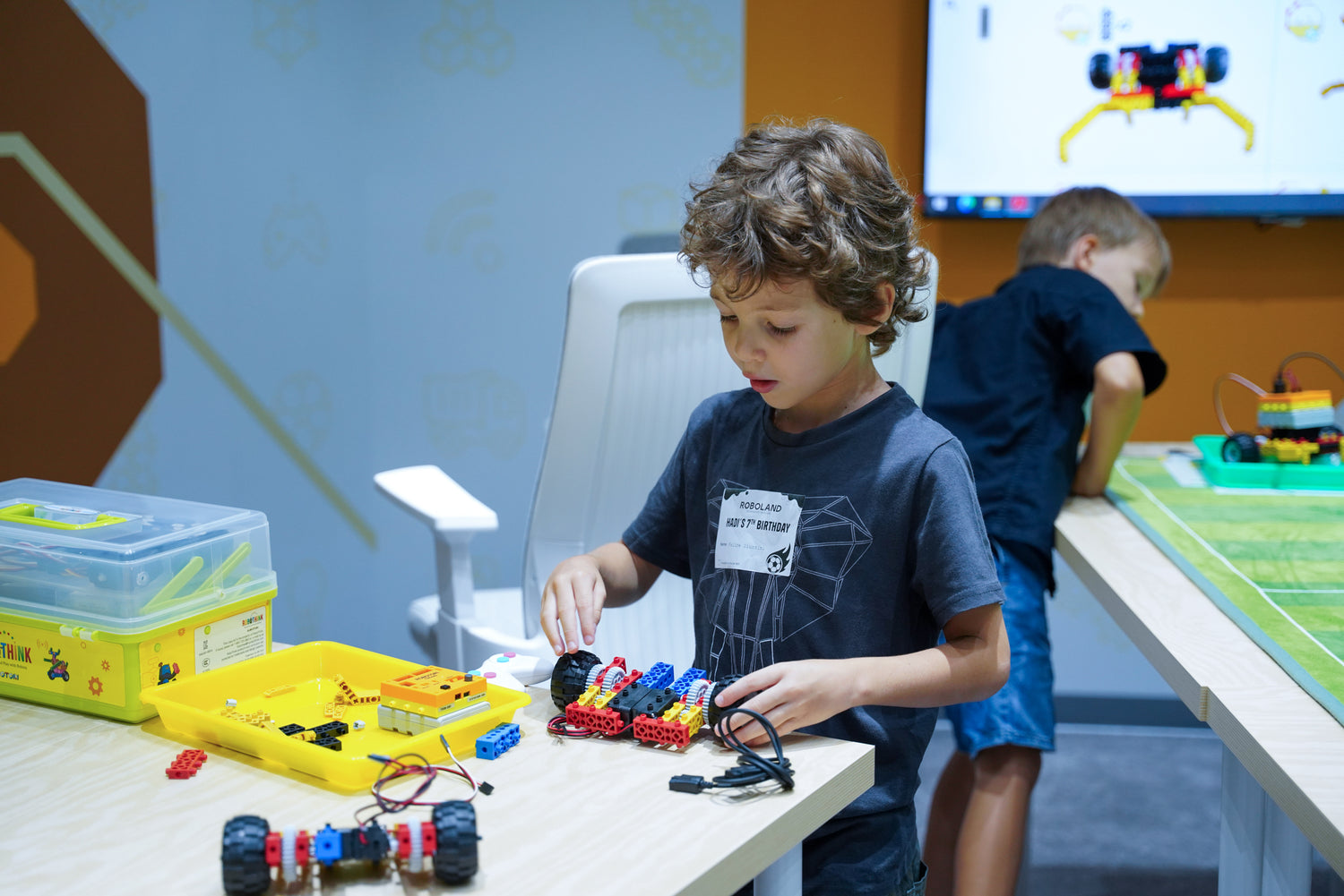 Children exploring STEM activities at RoboThink workshops, including coding and robotics, at RoboLand